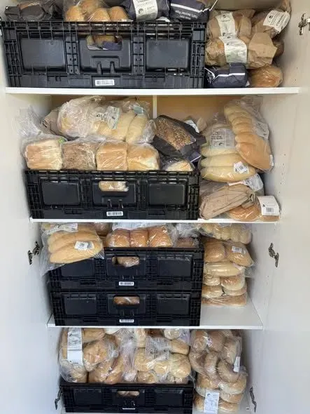 Shelves stocked with free bread for the community