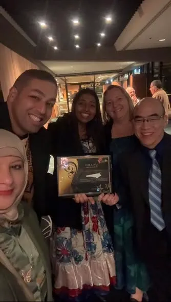The team celebrating with the award
